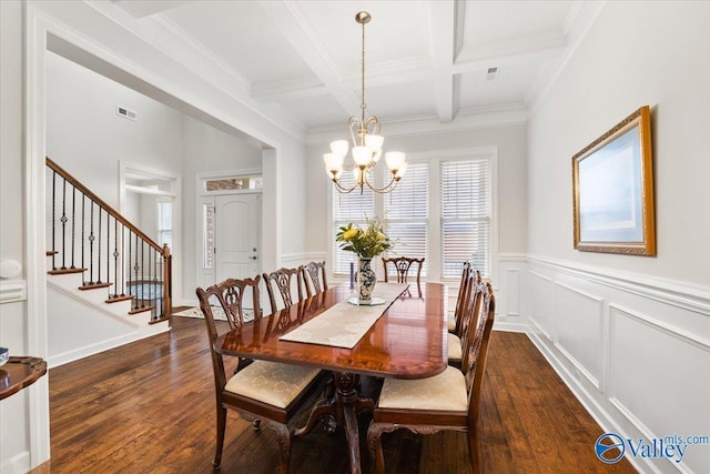 dining area featuring a notable chandelier, stairs, dark wood-style flooring, and beamed ceiling