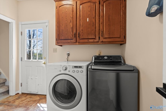 washroom with independent washer and dryer and cabinet space