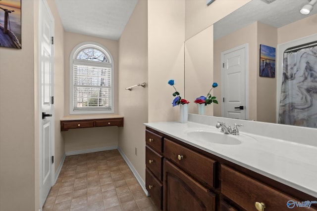 bathroom featuring vanity and baseboards