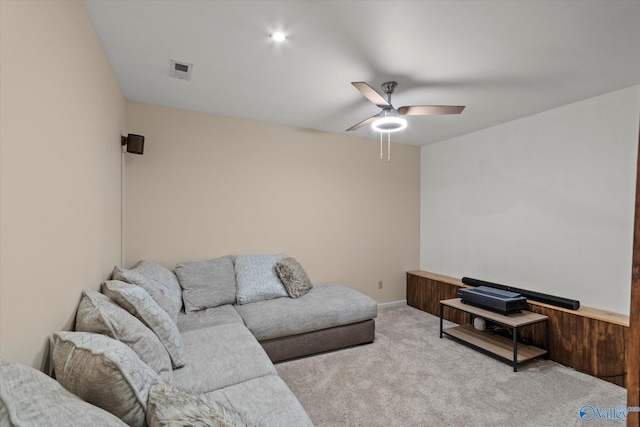 living room featuring baseboards, visible vents, carpet floors, and a ceiling fan