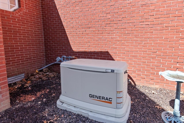 details featuring a power unit and brick siding