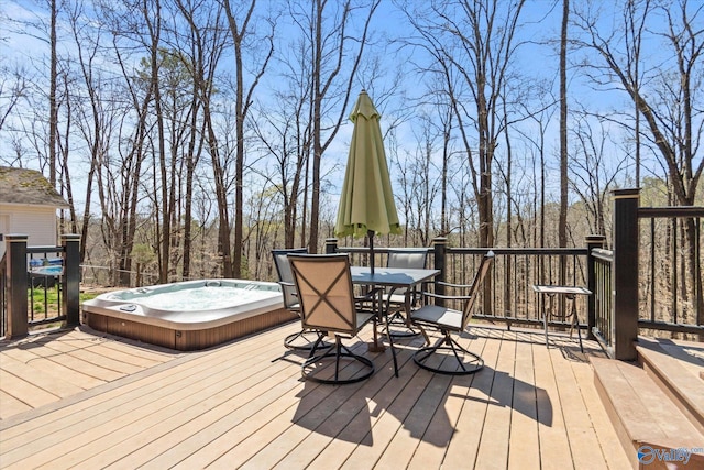 wooden deck featuring outdoor dining area and a hot tub