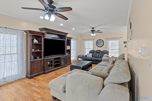 living area featuring recessed lighting, light wood-style floors, ceiling fan, and ornamental molding