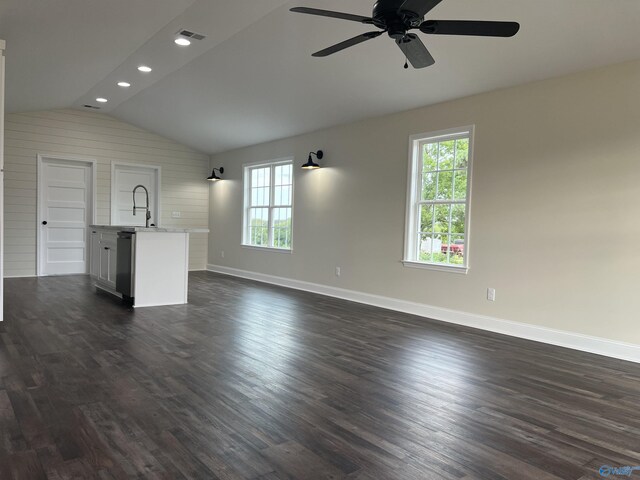 unfurnished living room with lofted ceiling, dark hardwood / wood-style floors, ceiling fan, and sink