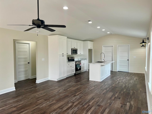 kitchen with ceiling fan, white cabinets, an island with sink, lofted ceiling, and stainless steel appliances