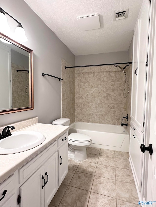 full bathroom with vanity, a textured ceiling, toilet, and tiled shower / bath