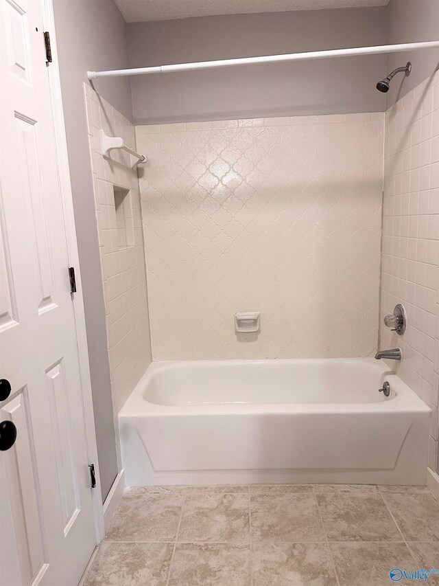 bathroom with tile patterned floors and tiled shower / bath