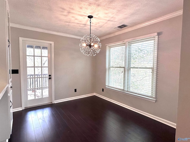 unfurnished dining area featuring a wealth of natural light, ornamental molding, dark hardwood / wood-style floors, and an inviting chandelier