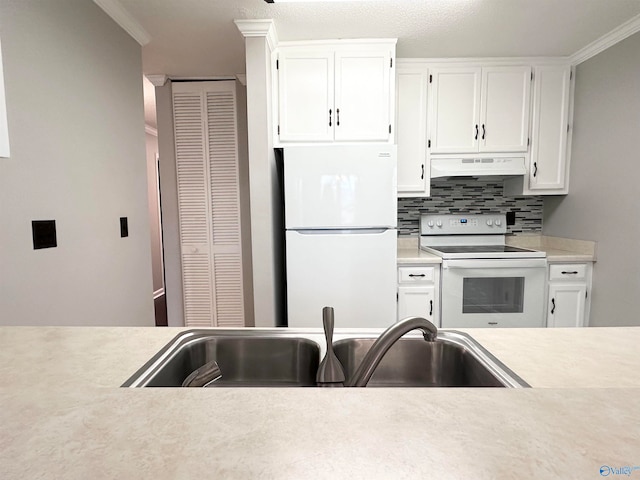 kitchen featuring white cabinets, white appliances, crown molding, and sink