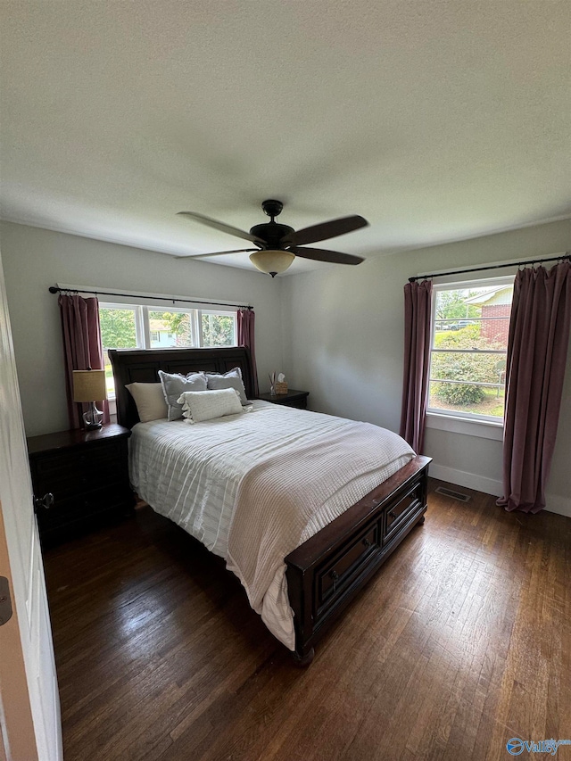 bedroom with ceiling fan and dark hardwood / wood-style flooring