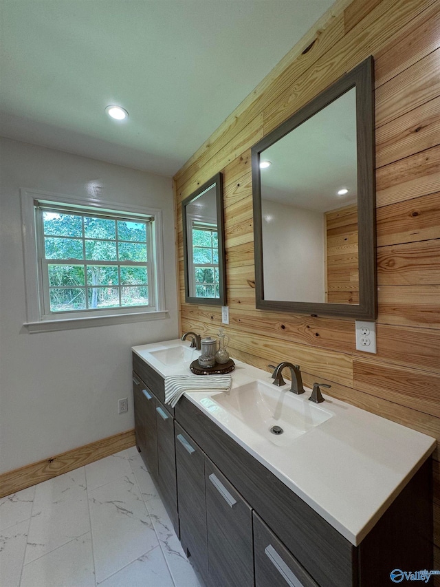 bathroom with vanity and wooden walls