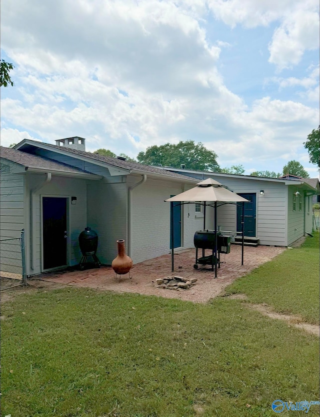 rear view of house with a patio area and a yard