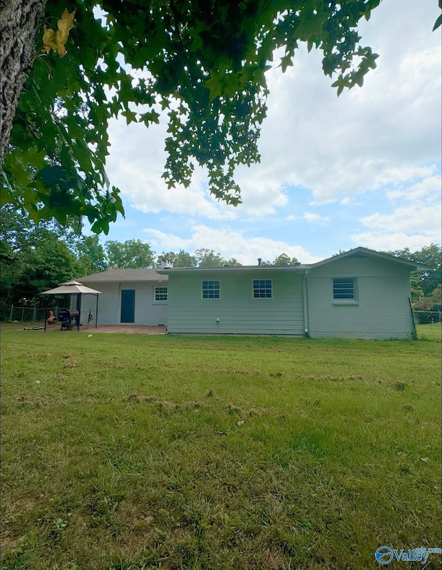 back of house featuring a yard and a patio area