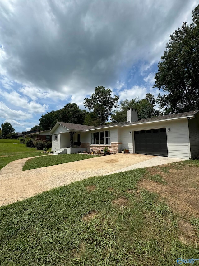 single story home featuring a garage and a front lawn