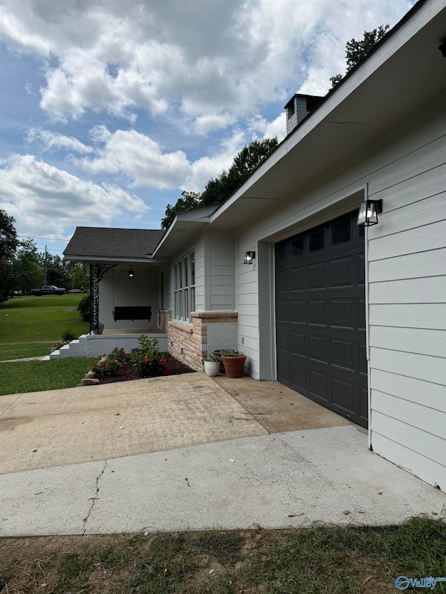 exterior space with a garage and a front lawn