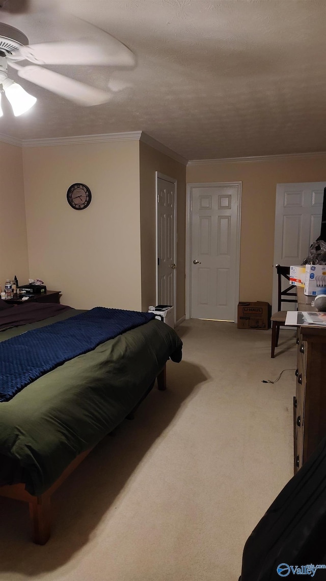 bedroom with a ceiling fan, crown molding, and light colored carpet