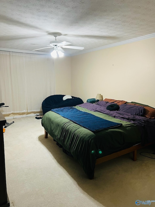 bedroom with a ceiling fan, carpet flooring, crown molding, and a textured ceiling