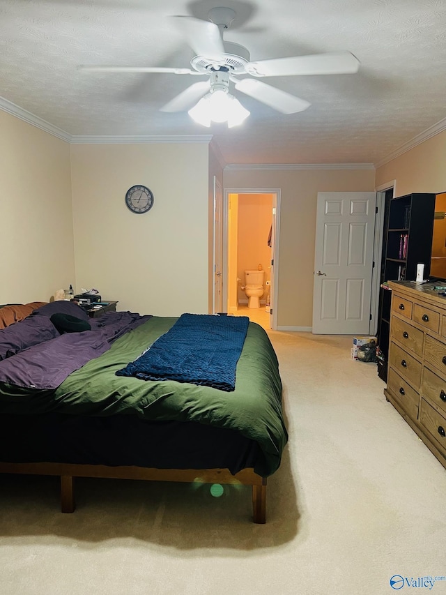 bedroom with ornamental molding, light carpet, connected bathroom, and a ceiling fan