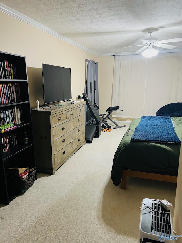 carpeted bedroom featuring a ceiling fan, ornamental molding, and a textured ceiling