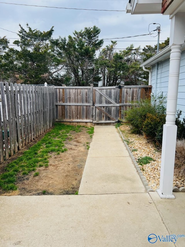 view of yard featuring fence and a gate