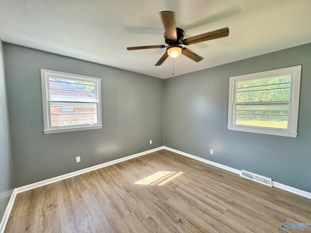 empty room featuring light wood-type flooring and ceiling fan