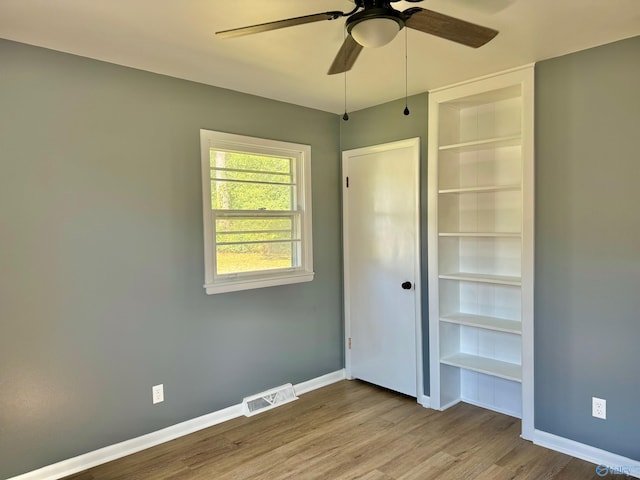 unfurnished bedroom featuring hardwood / wood-style floors and ceiling fan