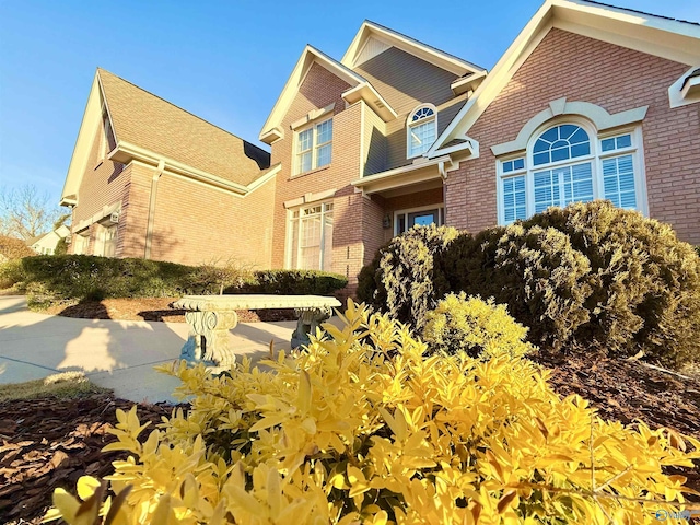 view of property exterior with brick siding