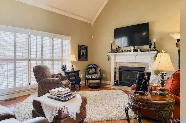 living room featuring a wealth of natural light, visible vents, vaulted ceiling, and crown molding