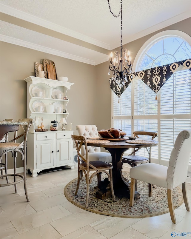 dining area with a textured ceiling, ornamental molding, and a notable chandelier