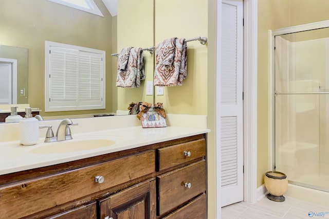 bathroom with a stall shower, vanity, and tile patterned floors