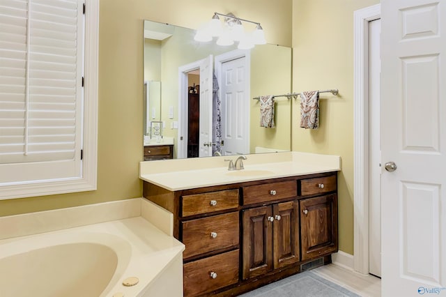 full bathroom featuring a garden tub, visible vents, and vanity