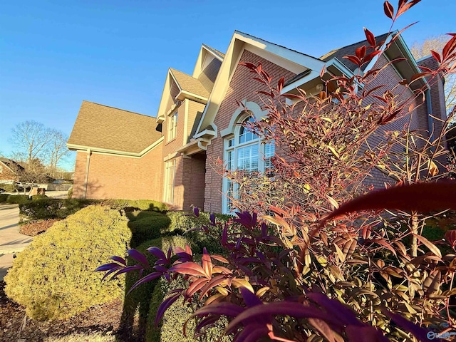 view of side of home featuring brick siding