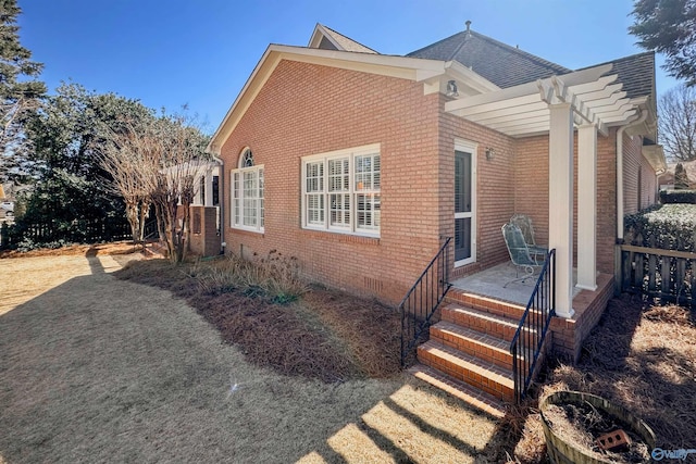 view of side of property with brick siding