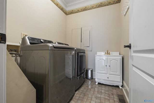 washroom with cabinets, sink, washer and clothes dryer, and ornamental molding