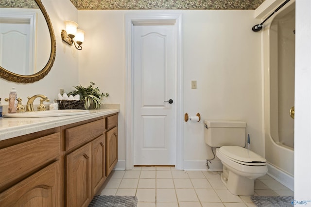 full bathroom featuring toilet, vanity, tile patterned floors, and shower / washtub combination