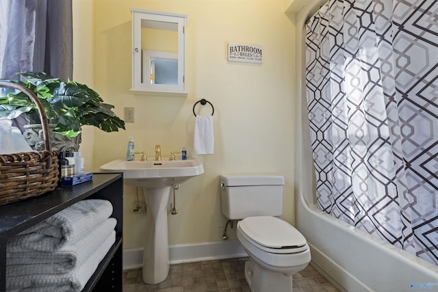 bathroom featuring toilet and shower / bath combination with curtain