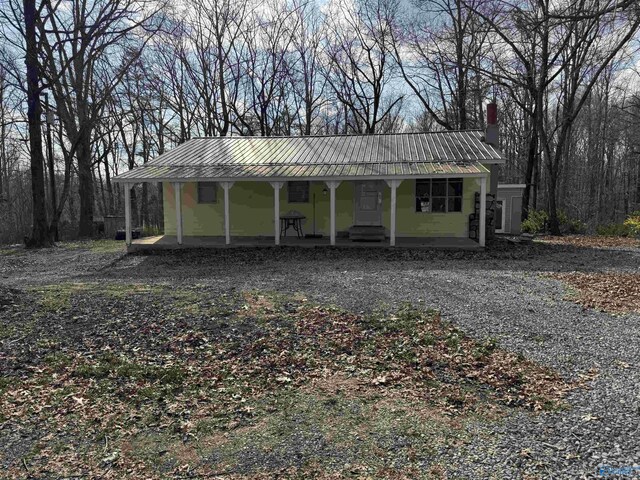 87 Flattop Cir, Scottsboro, AL 35768 - view of front facade featuring covered porch, a chimney, and metal roof