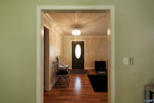 foyer entrance with dark wood-style floors, baseboards, and crown molding