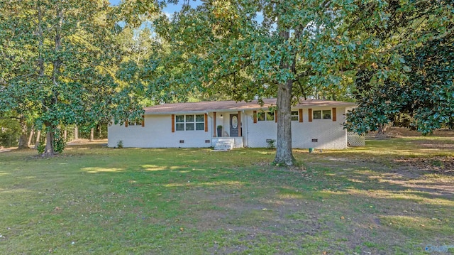 single story home featuring brick siding, crawl space, and a front yard