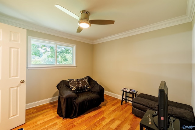 living area with light wood-style floors, baseboards, and crown molding