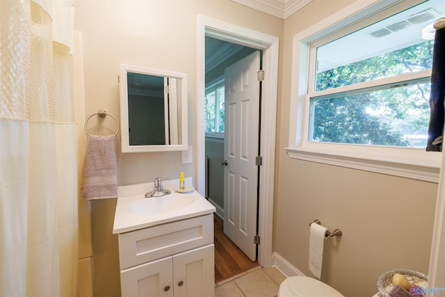 full bathroom featuring crown molding, visible vents, toilet, vanity, and tile patterned floors