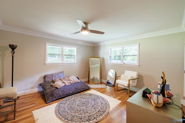 bedroom with crown molding, light wood-style flooring, and baseboards