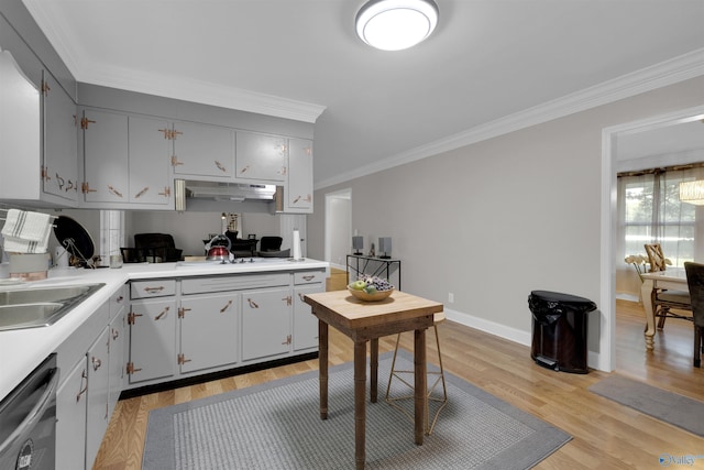 kitchen with under cabinet range hood, white gas cooktop, light countertops, dishwasher, and crown molding