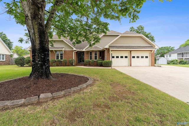 2303 Chatam Ave, Decatur, AL 35603 - view of front of house featuring an attached garage, brick siding, concrete driveway, a front lawn, and a shingled roof