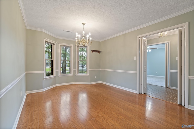2303 Chatam Ave, Decatur, AL 35603 - unfurnished room with a chandelier, wood finished floors, a textured ceiling, baseboards, and ornamental molding