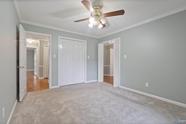 2303 Chatam Ave, Decatur, AL 35603 - unfurnished bedroom with carpet flooring, ornamental molding, a closet, a textured ceiling, and baseboards