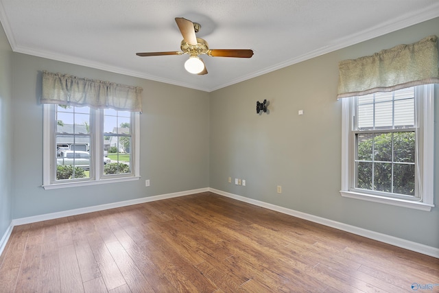2303 Chatam Ave, Decatur, AL 35603 - spare room featuring wood-type flooring, ceiling fan, baseboards, and crown molding