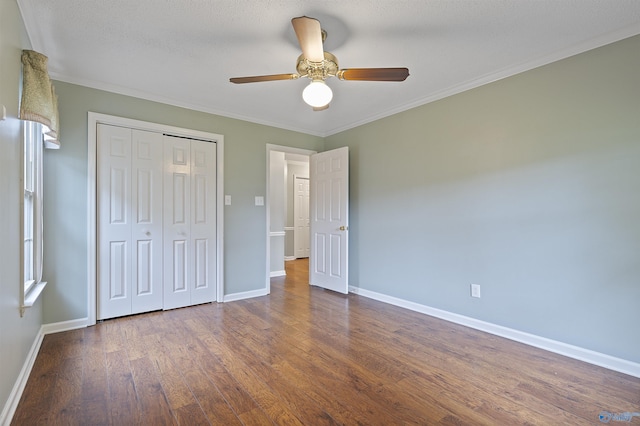 2303 Chatam Ave, Decatur, AL 35603 - unfurnished bedroom with dark wood-style floors, baseboards, a closet, crown molding, and a ceiling fan