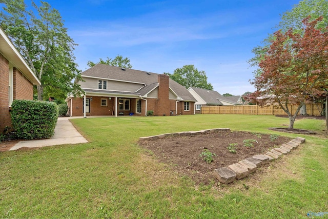 2303 Chatam Ave, Decatur, AL 35603 - rear view of property featuring brick siding and a chimney