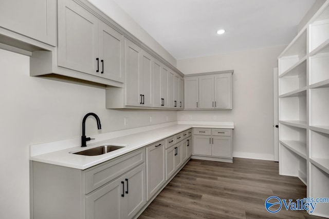 kitchen featuring dark hardwood / wood-style flooring, sink, and gray cabinets